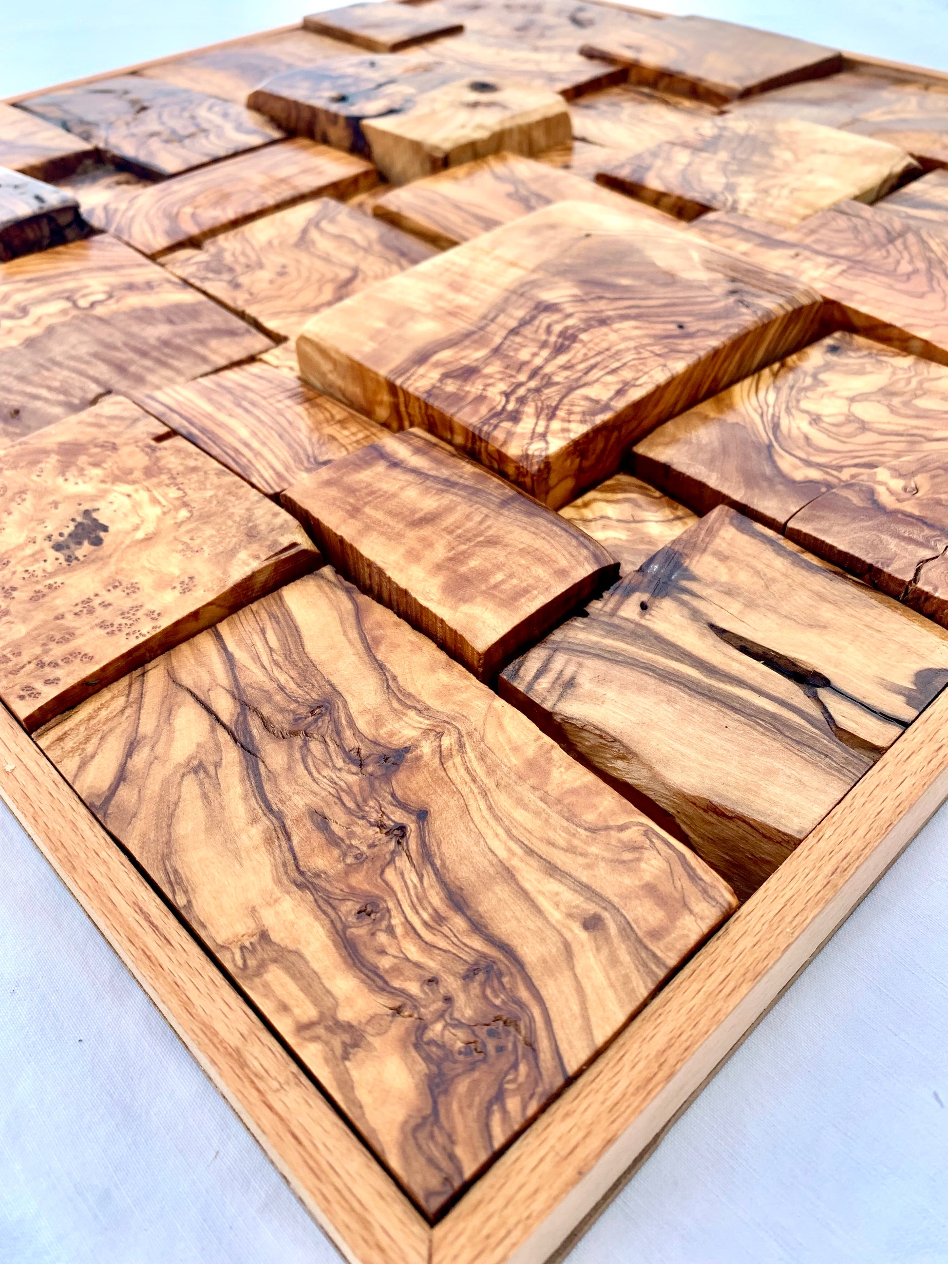Wooden mosaic tiles with a geometric pattern on a white background