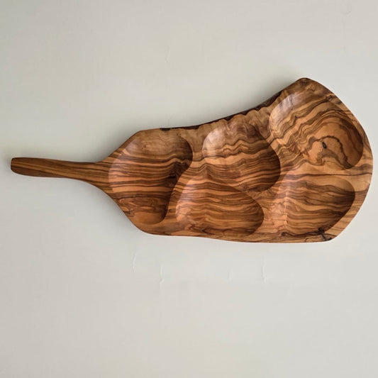 Wooden serving board with wavy grain pattern on a light gray background