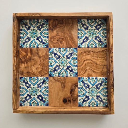 Wooden tray with a patterned tile design on a white background