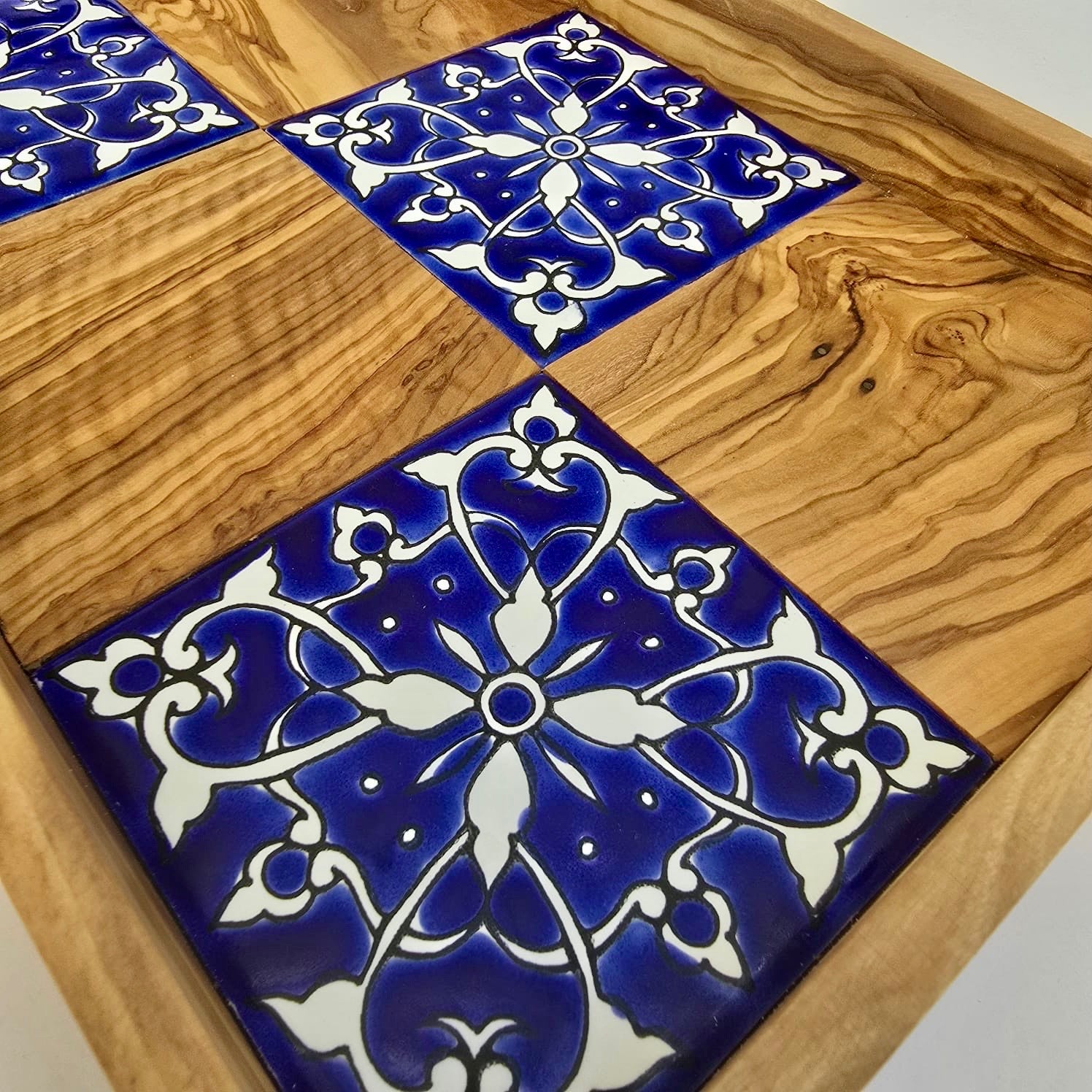 Blue and white decorative tiles on a wooden surface
